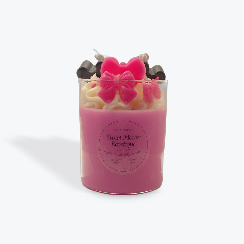 Pink candle with butterfly-shaped wick on a white background