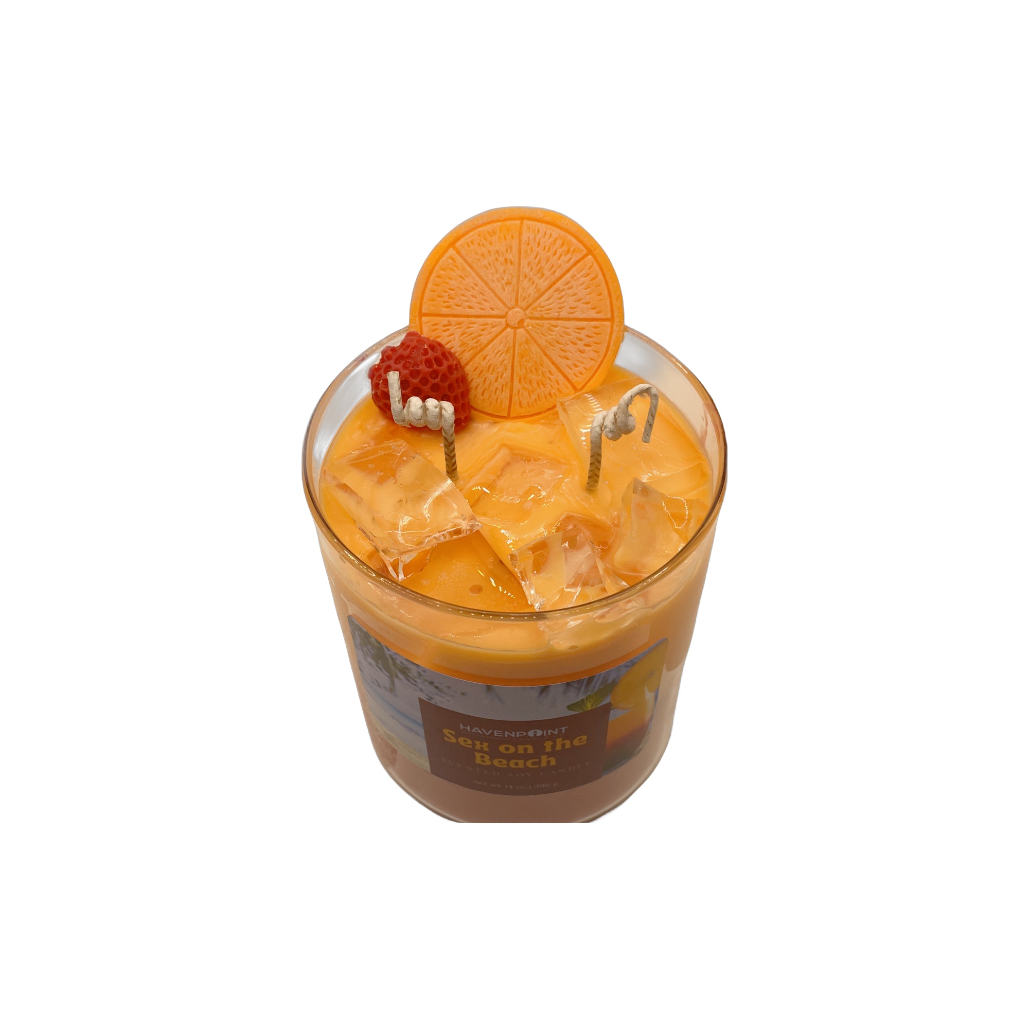 Candle in a glass jar with an orange slice and strawberry on top, labeled 'On the Beach'.