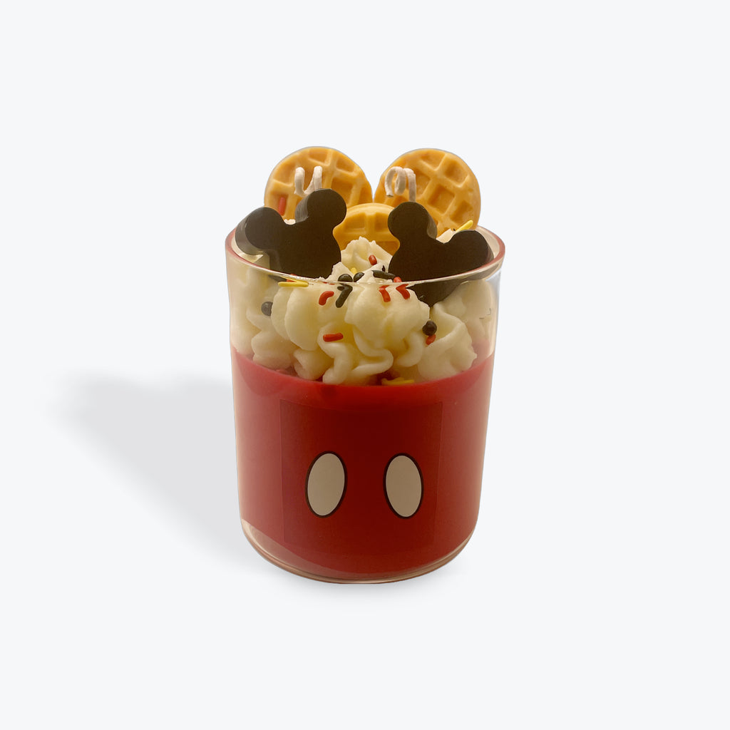 Cup with ice cream and waffles shaped like Mickey Mouse on a white background