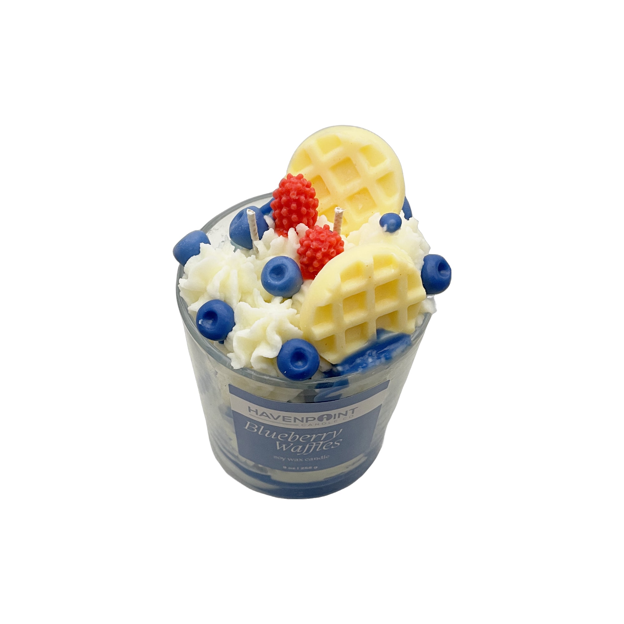 Candle in the shape of a blueberry waffle with waffle, blueberries, and strawberries on top, branded 'Havenpoint'.