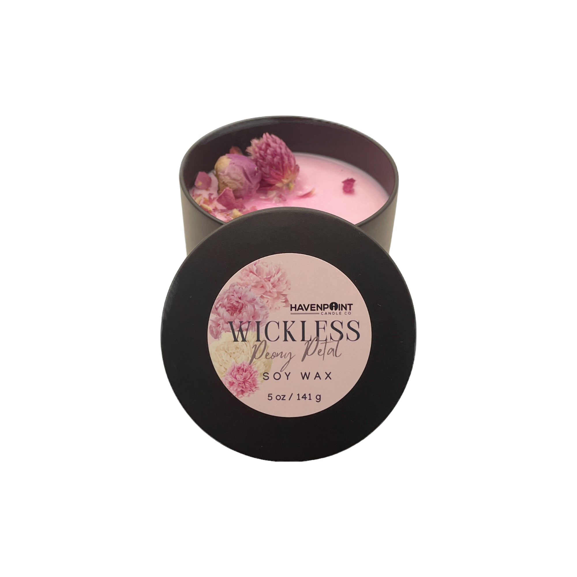 Pink candle in a black container with a floral label on a white background