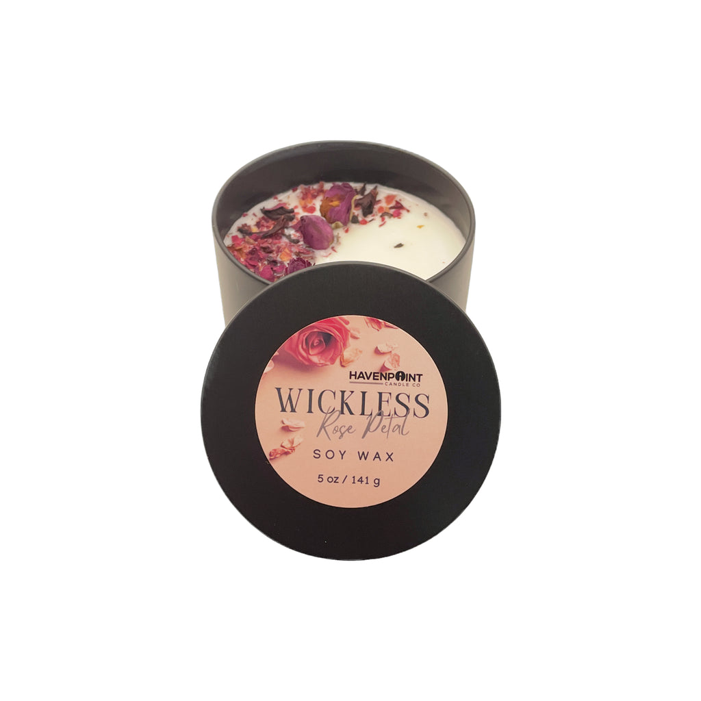 Candle in a tin with floral elements and 'Haven Point' branding on a white background