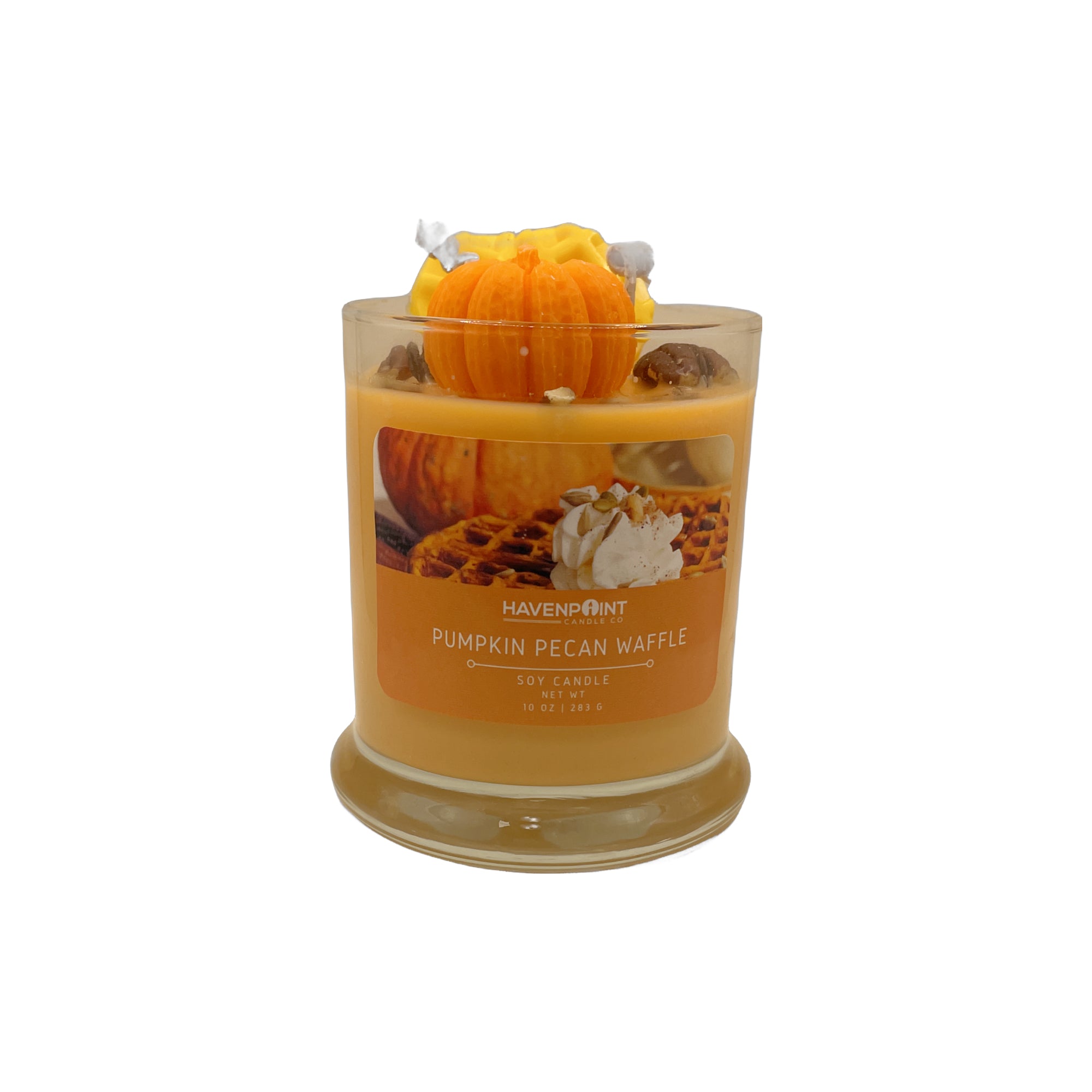 Candle with pumpkin decoration on a white background